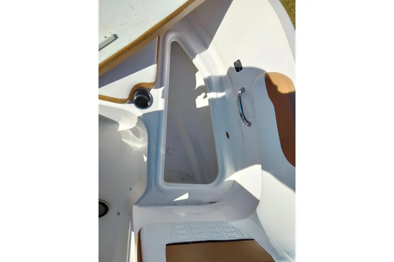 Slide: The Image of 2022 Bayliner VR6 Bowrider OB interior, featuring white and tan seating with storage compartment. - 3