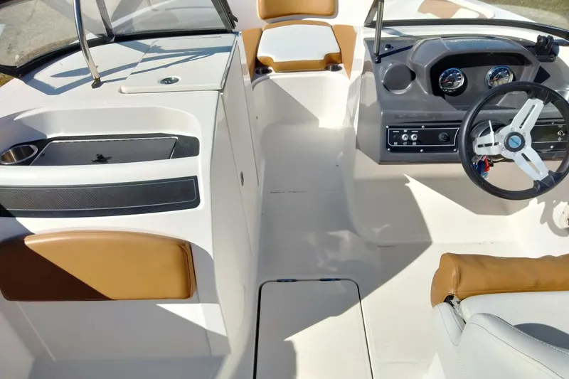 Slide: The Image of 2022 Bayliner VR6 Bowrider OB interior with steering wheel and seating. - 4