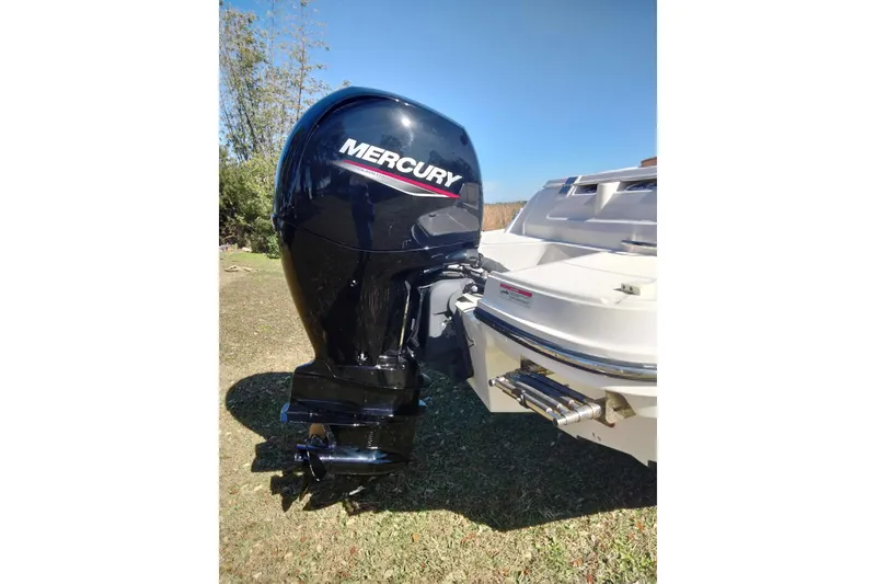 Slide: The Image of 2022 Bayliner VR6 Bowrider OB with Mercury outboard motor on grassy area. - 8