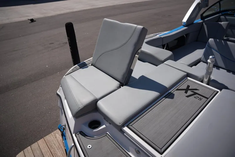 Slide: The Image of 2021 MasterCraft XT25 boat interior with gray seating and deck details. - 18