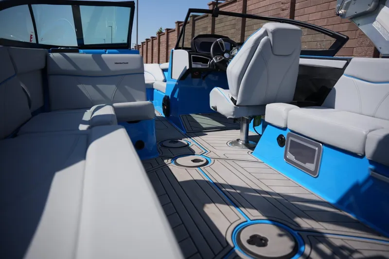 Slide: The Image of Interior of 2021 MasterCraft XT25 boat with modern seating and sleek design. - 13