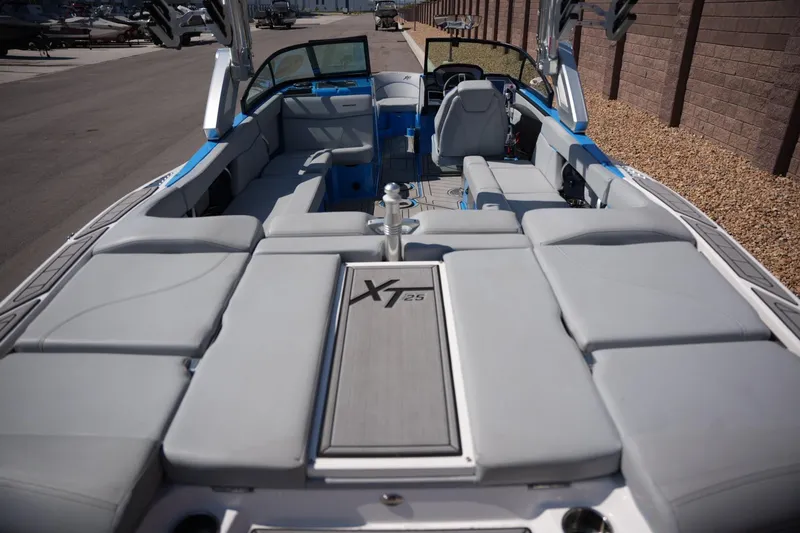Slide: The Image of 2021 MasterCraft XT25 boat interior with spacious seating and modern design. - 16