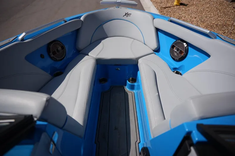 Slide: The Image of 2021 MasterCraft XT25 boat interior with blue and gray seating. - 8
