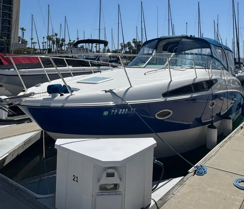 Slide: The Image of 2006 Bayliner 325 boat docked at marina with sailboats in background. - 1