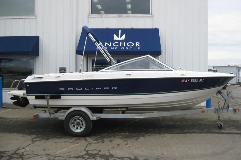 The Image of 2013 Bayliner 195 Discovery boat on trailer outside Anchor Marine Group. - 1