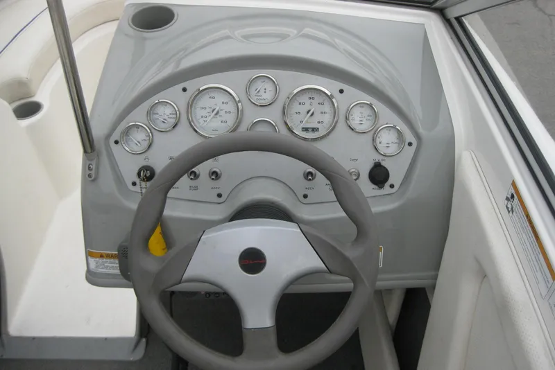 Slide: The Image of Dashboard of a 2013 Bayliner 195 Discovery boat with steering wheel and gauges. - 12