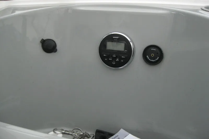 Slide: The Image of Control panel of 2013 Bayliner 195 Discovery boat with audio system and auxiliary input. - 14