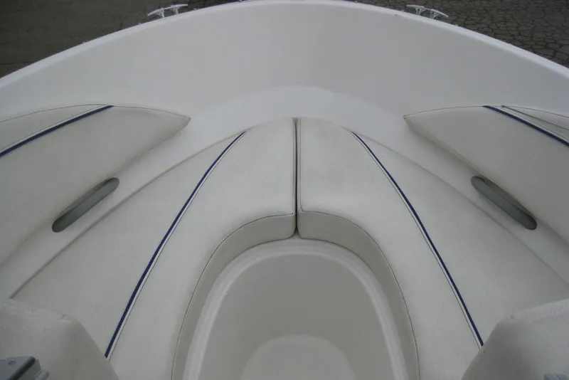 Slide: The Image of 2013 Bayliner 195 Discovery boat interior with white cushioned seating. - 15