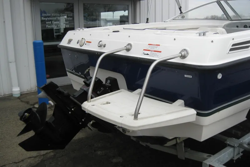 Slide: The Image of 2013 Bayliner 195 Discovery boat rear view with swim platform and outboard motor. - 5