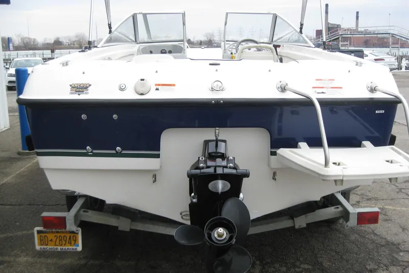Slide: The Image of 2013 Bayliner 195 Discovery boat, rear view with outboard motor, docked at marina. - 6