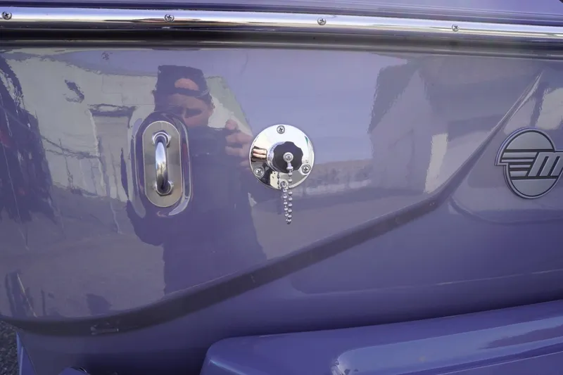 Slide: The Image of 2023 Malibu M220 boat exterior with logo and hardware details. - 12