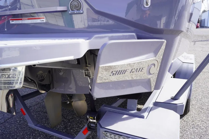 Slide: The Image of 2023 Malibu M220 boat with Surf Gate technology, rear view close-up. - 13