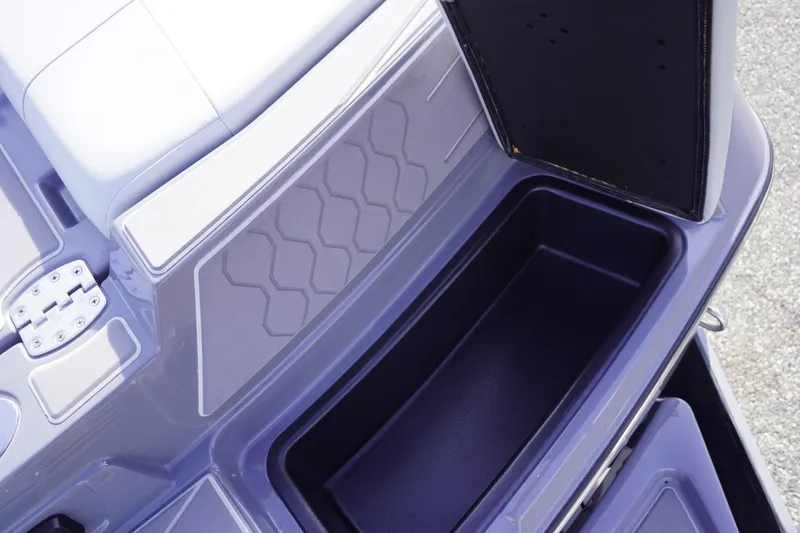 Slide: The Image of 2023 Malibu M220 boat storage compartment with open lid, showcasing interior space. - 22