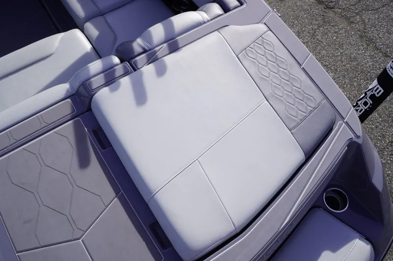 Slide: The Image of 2023 Malibu M220 boat interior with sleek, modern seating and textured upholstery design. - 25