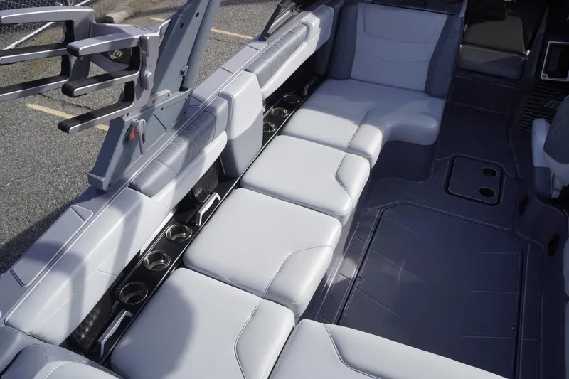 Slide: The Image of 2023 Malibu M220 boat interior with sleek seating and cup holders. - 27