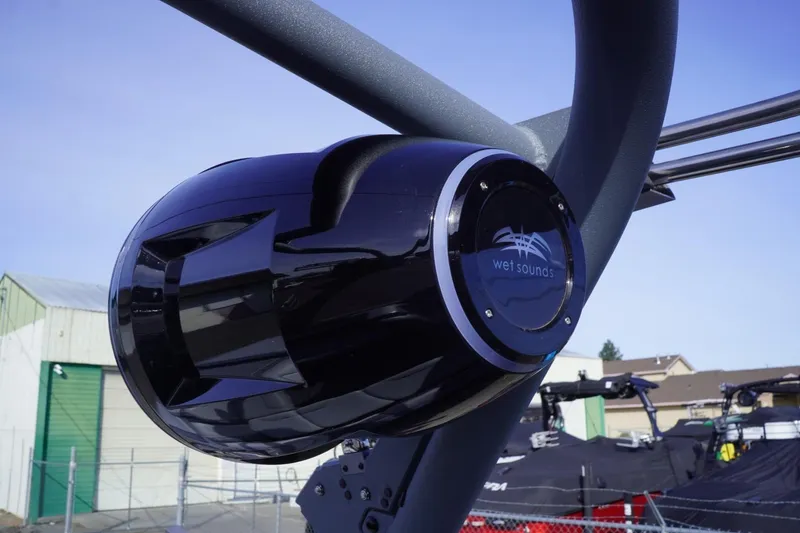 Slide: The Image of 2023 Malibu M220 boat with Wet Sounds speaker, outdoor setting. - 33