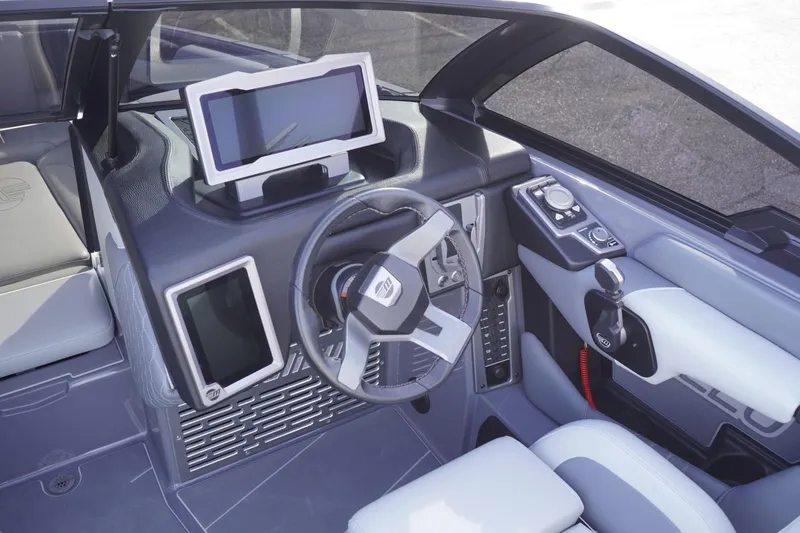 Slide: The Image of 2023 Malibu M220 boat cockpit with modern steering and touchscreen controls. - 35