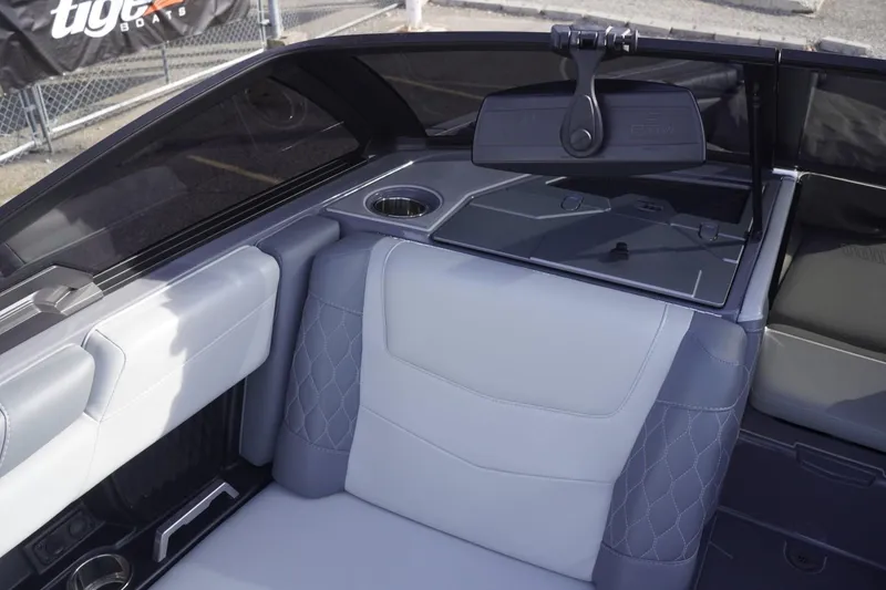Slide: The Image of 2023 Malibu M220 boat interior with gray seating and cup holders. - 36