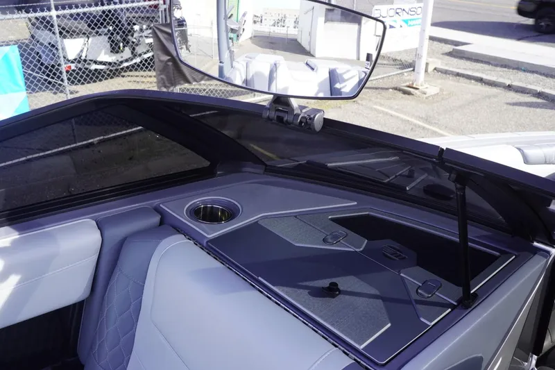 Slide: The Image of 2023 Malibu M220 boat interior with sleek design and cup holder. - 37
