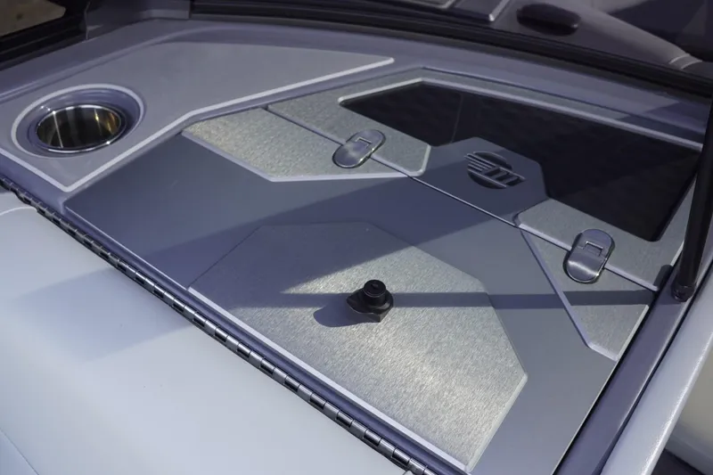 Slide: The Image of 2023 Malibu M220 boat deck with sleek design and integrated cup holder. - 38