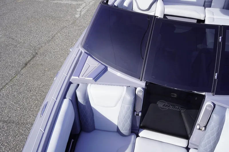 Slide: The Image of 2023 Malibu M220 boat interior with sleek seating and tinted windshield. - 41