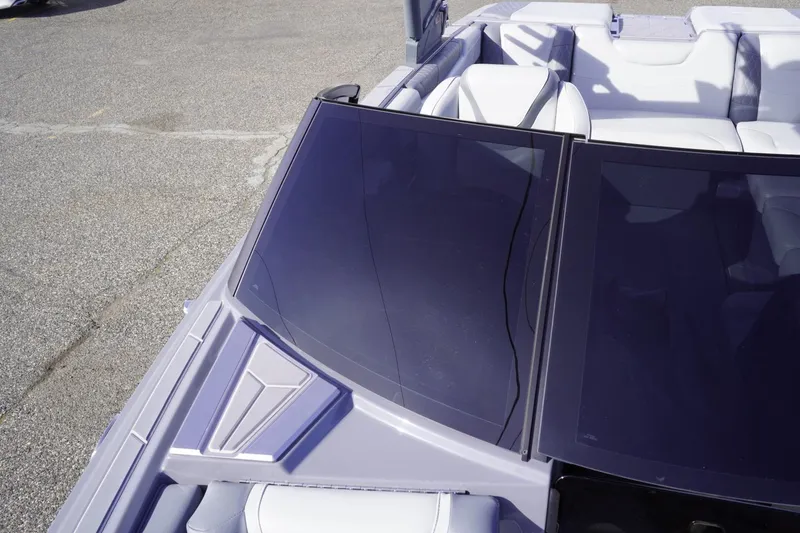 Slide: The Image of 2023 Malibu M220 boat with sleek windshield and luxurious seating. - 45