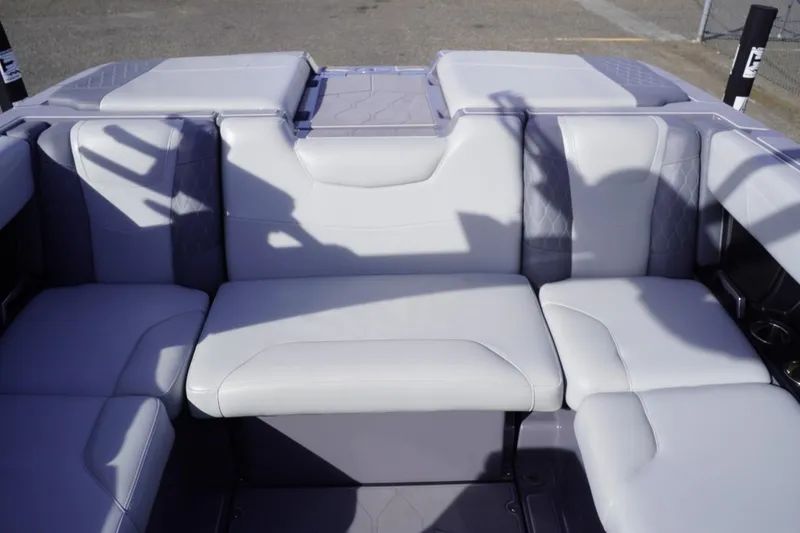 Slide: The Image of 2023 Malibu M220 boat interior with white cushioned seating. - 51