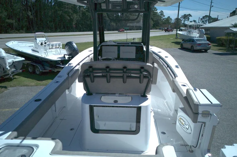 Slide: The Image of 2026 Sea Hunt Gamefish 25 boat interior with Garmin electronics, parked outdoors. - 11