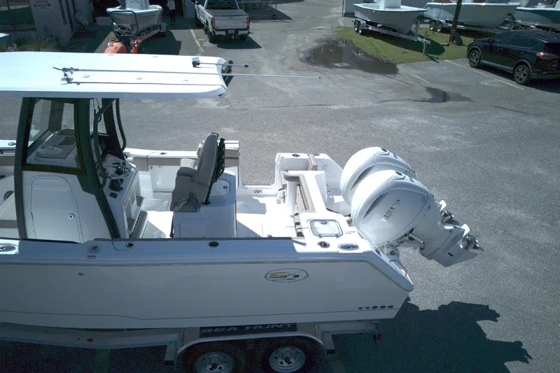 Slide: The Image of 2026 Sea Hunt Gamefish 25 boat with dual Yamaha outboard motors on a trailer. - 13