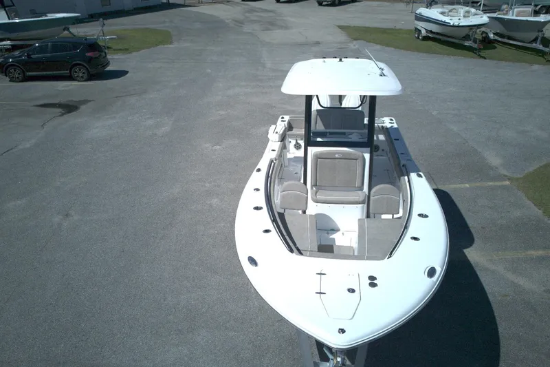 Slide: The Image of 2026 Sea Hunt Gamefish 25 boat on display in a parking lot. - 6