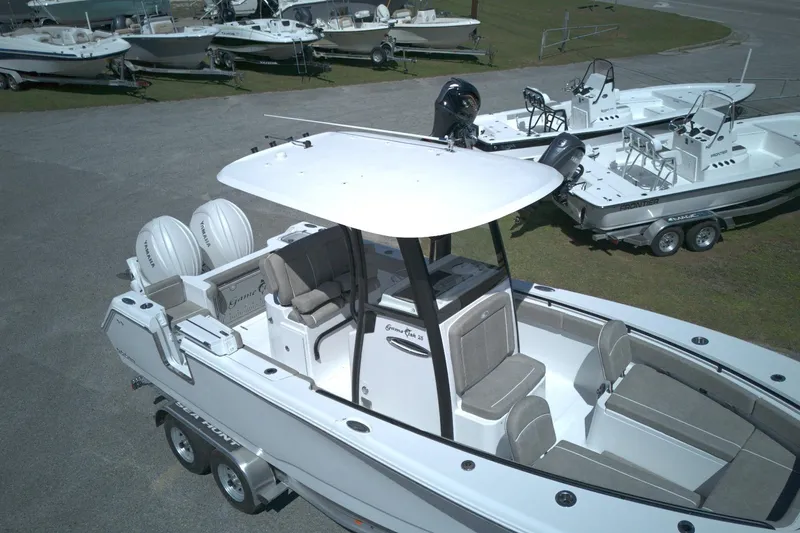 Slide: The Image of 2026 Sea Hunt Gamefish 25 boat with dual engines, parked on a trailer. - 7