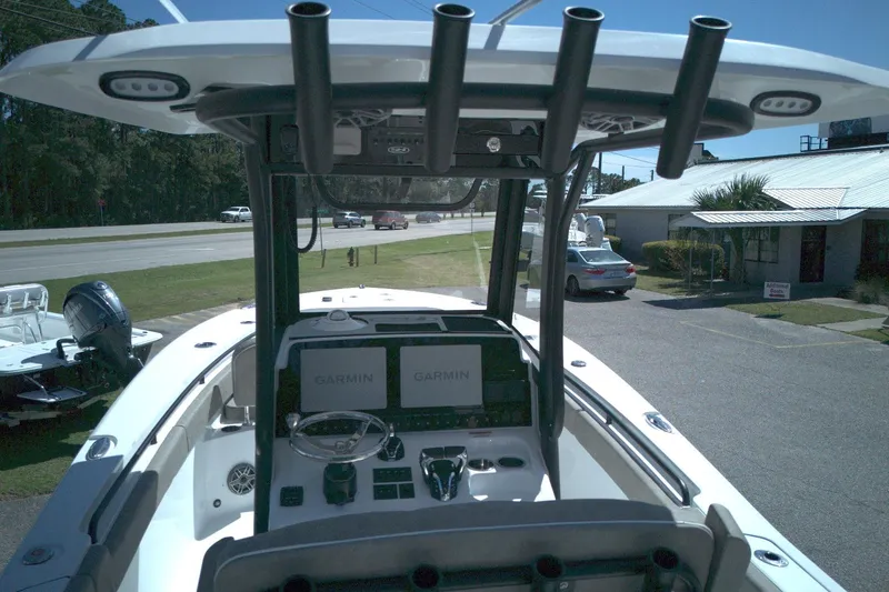 Slide: The Image of 2026 Sea Hunt Gamefish 25 boat dashboard with Garmin displays and steering wheel. - 9