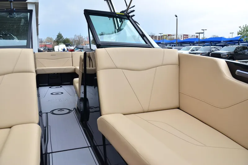 Slide: The Image of 2023 MasterCraft NXT24 boat interior with beige seating and sleek design. - 10