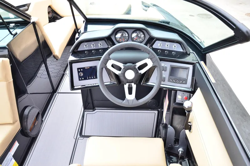 Slide: The Image of 2023 MasterCraft NXT24 boat cockpit with modern steering and control panels. - 11