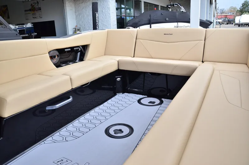 Slide: The Image of 2023 MasterCraft NXT24 boat interior with beige seating and modern design. - 12