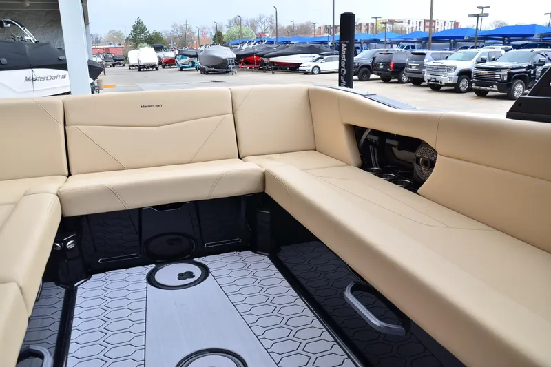 Slide: The Image of 2023 MasterCraft NXT24 boat interior with beige seating and modern design. - 15