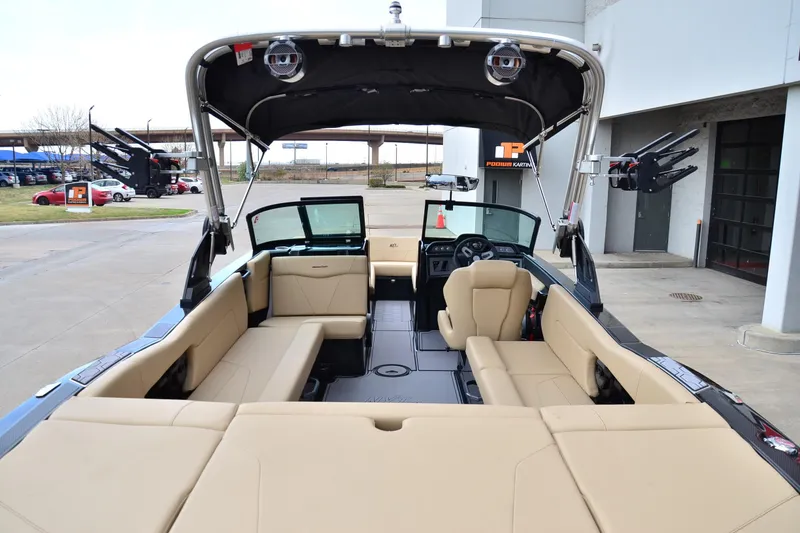 Slide: The Image of 2023 MasterCraft NXT24 boat interior with beige seating and modern dashboard. - 18
