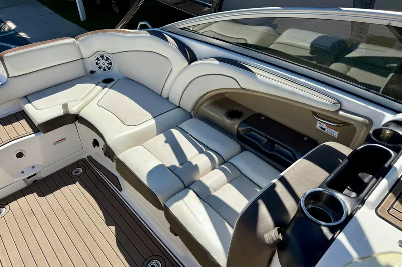 Slide: The Image of Interior seating of a 2013 Yamaha Boats 242 Limited S, featuring cushioned seats and cup holders. - 11