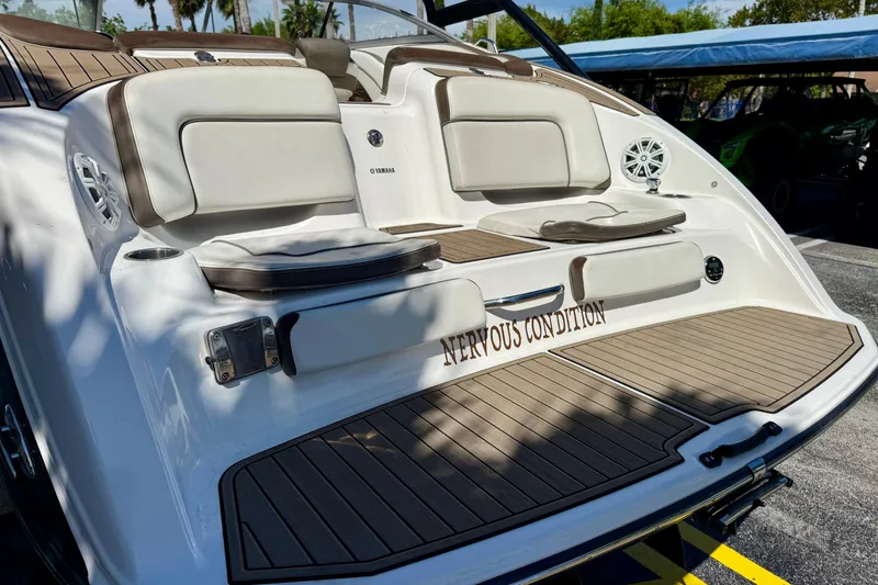 Slide: The Image of 2013 Yamaha Boats 242 Limited S with cushioned seating and teak-style flooring. - 7