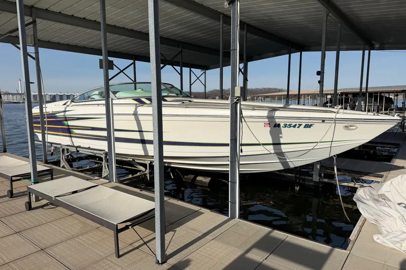 The Image of 2001 Formula 312 FASTech boat docked in a marina, featuring sleek design and vibrant graphics. - 1