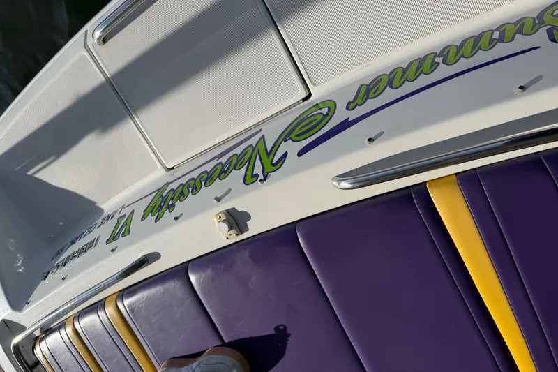 Slide: The Image of 2001 Formula 312 FASTech boat with purple and yellow seating, custom graphics. - 17