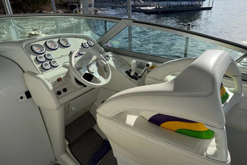 Slide: The Image of Interior of a 2001 Formula 312 FASTech boat with white leather seating and control panel. - 23