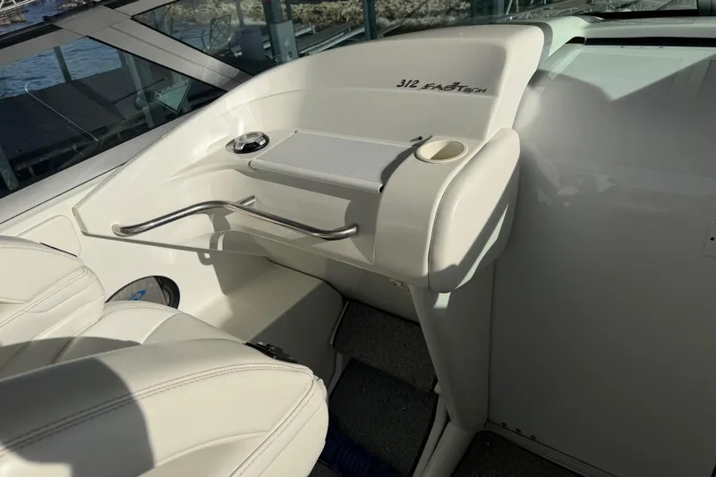 Slide: The Image of 2001 Formula 312 FASTech boat interior with white seating and dashboard details. - 24