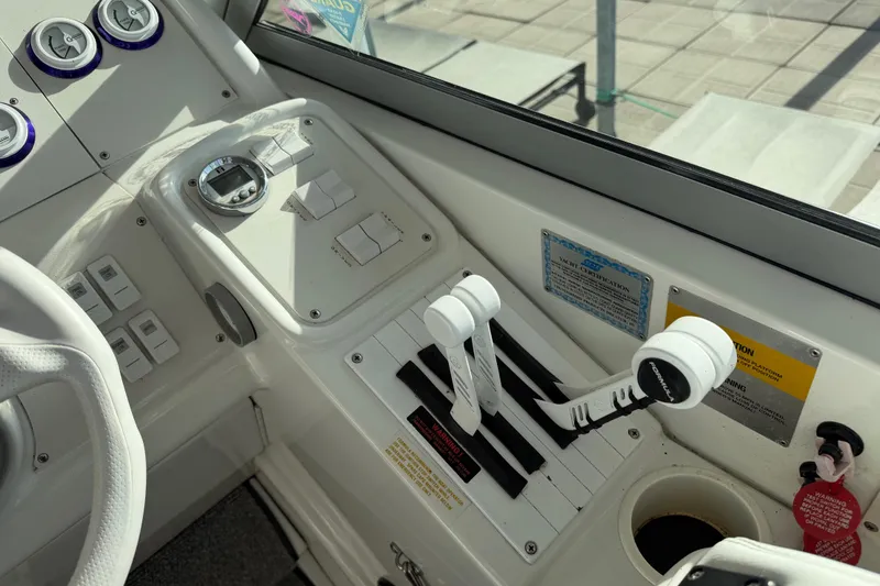 Slide: The Image of Control panel of a 2001 Formula 312 FASTech boat with throttle levers and gauges. - 25