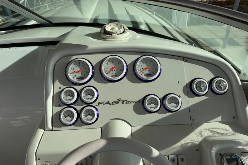 Slide: The Image of Dashboard of a 2001 Formula 312 FASTech boat with multiple gauges and compass. - 26