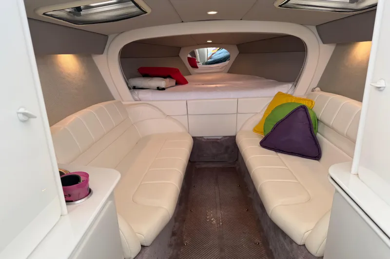 Slide: The Image of Interior of a 2001 Formula 312 FASTech boat with plush seating and colorful cushions. - 29