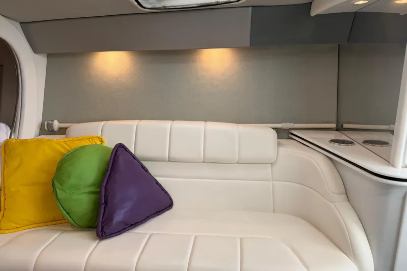 Slide: The Image of Interior of 2001 Formula 312 FASTech boat with white seating and colorful cushions. - 34