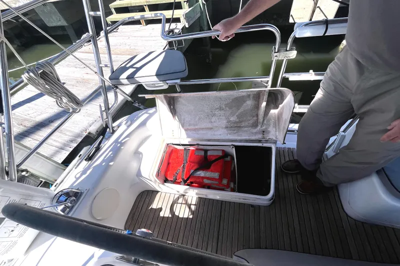 Slide: The Image of 2006 Catalina 400 MkII yacht with open storage compartment and visible life jacket. - 13
