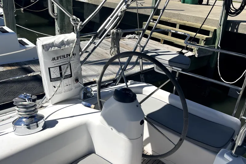 Slide: The Image of Cockpit of 2006 Catalina 400 MkII sailboat with steering wheel and safety equipment. - 16
