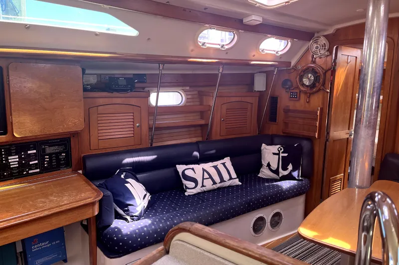Slide: The Image of Interior of 2006 Catalina 400 MkII sailboat with nautical-themed cushions and wooden cabinetry. - 19